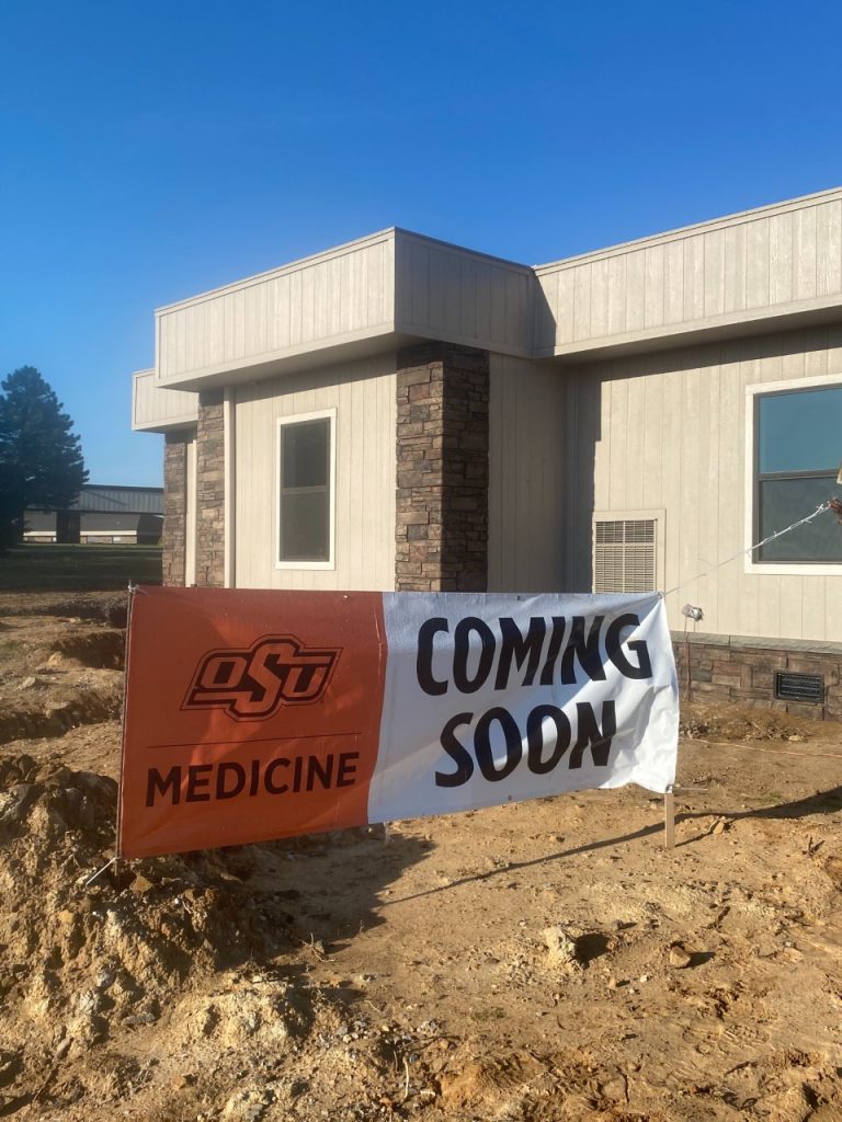 OSU Medicine in Oklahoma built a modular  rural health clinic with Rose Medical Buildings, a division of Rose Office Buildings. This shows the building with a "Coming Soon" banner out front. 