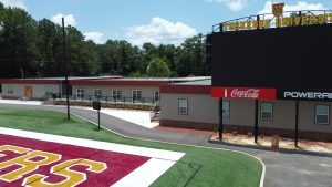 Football field athletic facilities built by Rose- Player Lounge, VIP Presidential Suite, Locker Room, Equipment room, Physical Therapy, Training Classrooms and Office Spaces at the end of Cleve Abbott Field - Drone Shot
